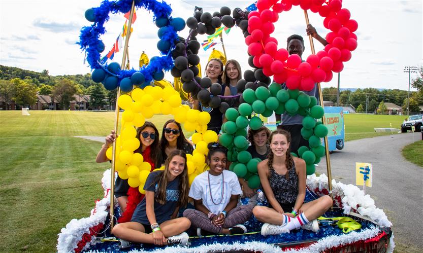 Students celebrate while on a homecoming parade float